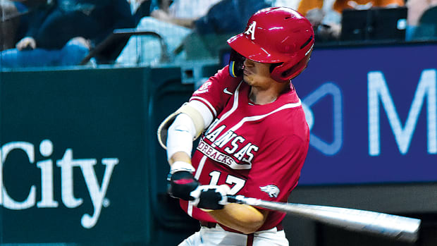 Arkansas Razorback Brady Slavens takes a cut against the Texas Longhorns at Globe Life Field.